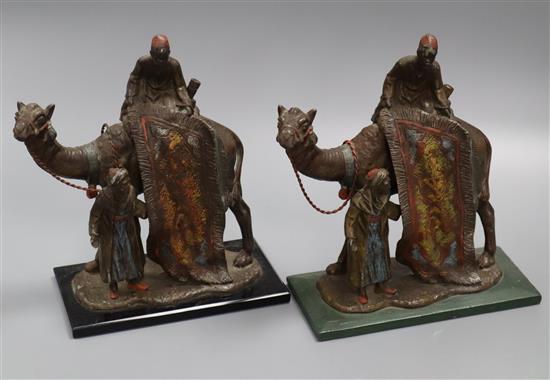 A pair of spelter lighters modelled as carpets sellers on camels